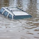 Catastrophic Floods Trap 100,000 – Governor Desperate for Help! A partially submerged vehicle in floodwaters