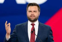 Vance Announces PREGNANCY – Breaks 248-Year Record! Man in a suit speaking at an event.