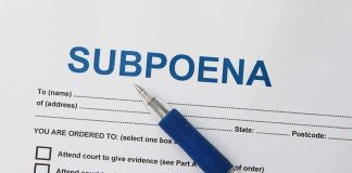A subpoena document with a blue pen resting on it