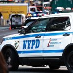 NYPD Ambushed — Mayor’s Silence Sparks Fury NYPD police car on a city street scene.
