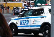 NYPD Ambushed — Mayor’s Silence Sparks Fury NYPD police car on a city street scene.