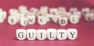 Dice spelling GUILTY on a red surface.