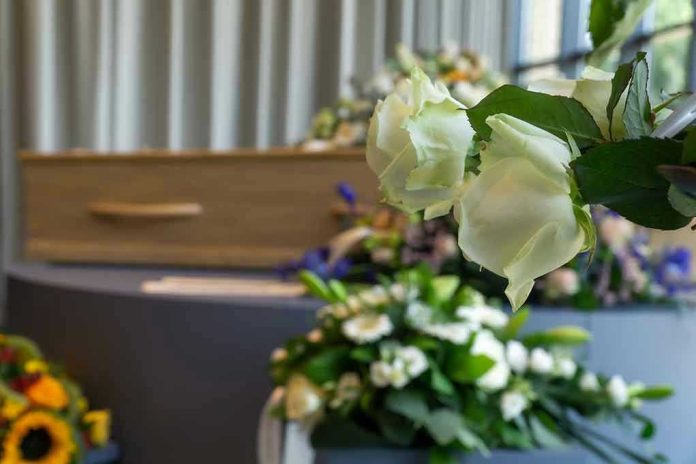 1518299909 White roses in front of a casket.