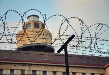 Prison Smugglers BUSTED – Elaborate Scheme Goes Horribly Wrong Barbed wire in front of a prison tower.