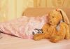Father CONFESSES Abusing Infant — 30 Broken Bones! A cozy bedroom scene featuring a stuffed bunny and pink bedding