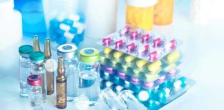 Doping Allowed in Vegas Enhanced Games! Vials and blister packs of pills on table.