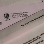 IRS Lawsuit Twist: $1.7B Deal? IRS letters and envelopes on a table.