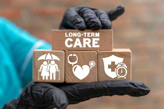 2048819804 Gloved hand holding longterm care wooden blocks