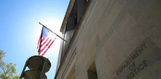 Washington Targets Brazil’s Top Crime Syndicates American flag at Department of Justice building exterior.