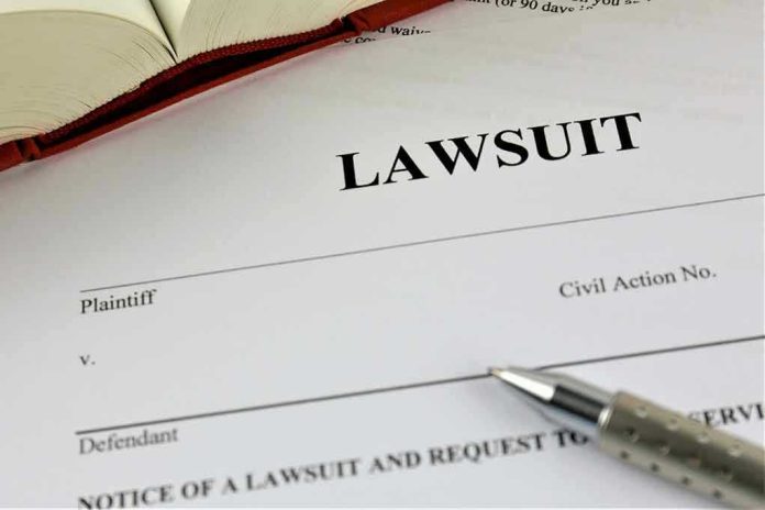 775826128 Lawsuit document with a pen and book.