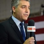 Man holding CNN microphone at event