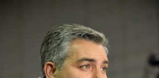 Man holding CNN microphone at event