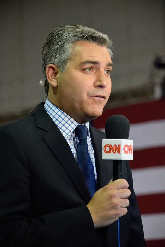 Man holding CNN microphone at event