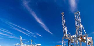 Global Tax Bombshell Hits Shipping Cargo ship docked at port with cranes unloading.