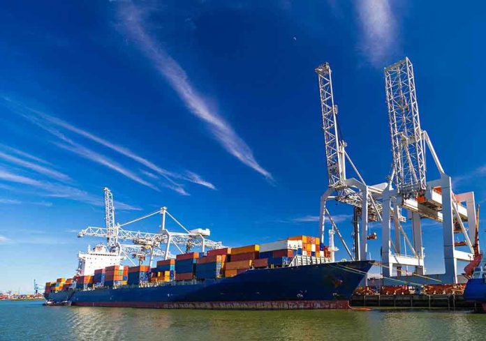 283990010 Cargo ship docked at port with cranes unloading.