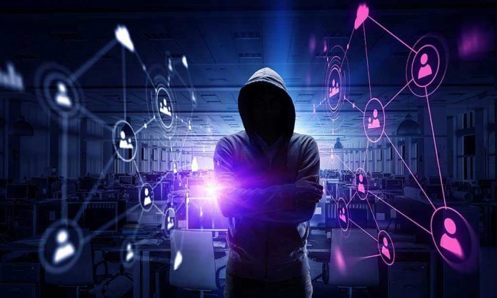 Hacker in hooded sweatshirt with digital connections overlay.