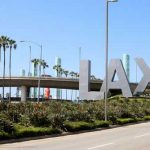 World Cup Fans Confront LAX Reality LAX sign with palm trees and blue sky