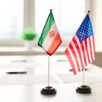 Mini flags of Iran and the United States on a conference table