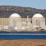 Stocks Soar on Iran Ceasefire, But the War May Not Be Over Nuclear power plant with domed structures beside a water body and mountains in the background