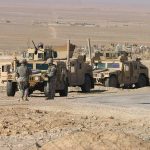 Ceasefire Clock Ticks — A Rare Pause in Israel–Hezbollah Conflict Two military humvees with soldiers in a desert landscape