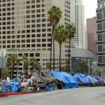 Street lined with tents and makeshift shelters downtown.
