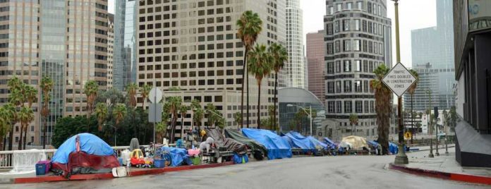 1469142698 Street lined with tents and makeshift shelters downtown.