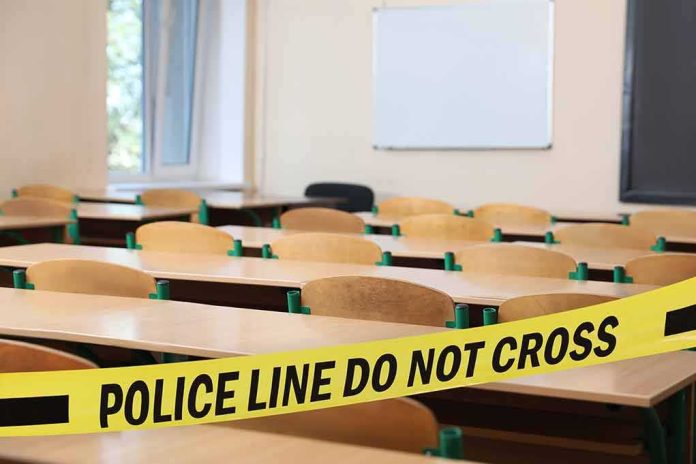 shutterstock_2344759813 Empty classroom with police tape across desks