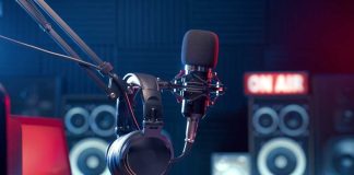 Close-up of a microphone and headphones in a podcast studio