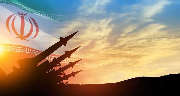 shutterstock_2377780377 missile silhouettes under Iran flag at sunset