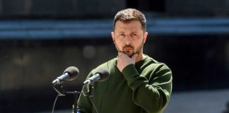 False Claims Misidentify Ukraine’s New Defense Leadership A public figure in a green sweater pondering during a speech at a podium in Kyiv