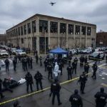 Police officers and FBI agents at a crime scene with a drone overhead
