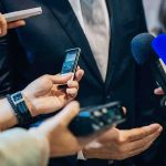Reporter Phone Records Pulled in Air Force One Investigation businessperson in suit surrounded by microphones and recorders