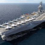 Trump Threatens Iran With a “Massive Attack” Aircraft carrier at sea with fighter jets on deck