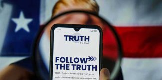 Trump’s Latest AI Spree Has Everyone Talking Phone screen displaying Truth Social app magnified