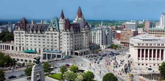 All 9 Skiers Died Trapped Under Castle Peak Snow Urban square with war memorial and grand chateau-style building