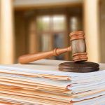 Key Gun Rules Struck Down as DOJ Skips Appeal judge's gavel resting on a stack of case files