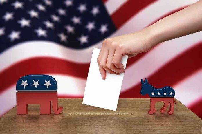 shutterstock_102884888-1 Hand casting ballot between Republican elephant and Democratic donkey
