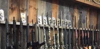 140 Guns Sent to Mexican Cartels rack of rifles and shotguns in a gun store