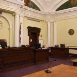 empty courtroom with judge's bench and columns
