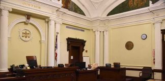 empty courtroom with judge's bench and columns