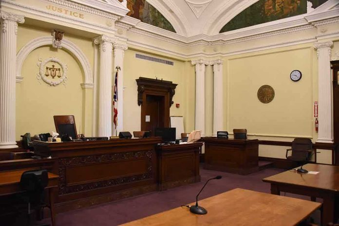 shutterstock_1292266861-2 empty courtroom with judge's bench and columns