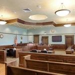 Parents vs. Texas: Who Controls Religion in the Classroom? Empty courtroom with wooden benches and judge's bench