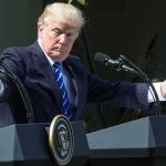 Trump Stuns Markets With Military Bond Remark man at podiums with arms outstretched during outdoor press event
