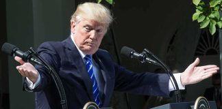 Trump Stuns Markets With Military Bond Remark man at podiums with arms outstretched during outdoor press event