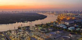 Ukraine’s Drones Are Hitting Russia’s Oil Lifeline Industrial oil refinery complex beside a river at dusk