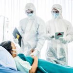 The Ebola Hunt Is Running Out of Time Healthcare workers in full PPE attending to a hospital patient