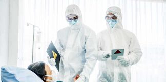 The Ebola Hunt Is Running Out of Time Healthcare workers in full PPE attending to a hospital patient