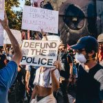 Abolition Question Leaves Activist Stuck Protesters holding signs at a street demonstration