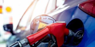 Trump-Promoted Gas Stations Face Fuel Lawsuit Red gasoline nozzle fueling a blue car