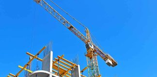 Tower crane over concrete building under construction